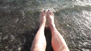 On public beach I sit on the shore wearing shorts and t-shirt and wetting my feet in the sea ...