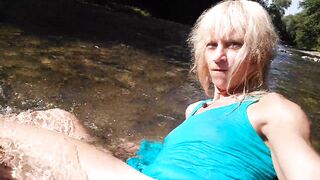 Sexy t-girl swimming in mountain river and wetting teal summer dress ...