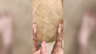 Hairy veiny uncut dick pissing with an erection on the bathroom floor