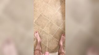 Hairy veiny uncut dick pissing with an erection on the bathroom floor