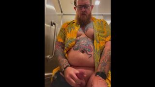 Bearded Tattooed Daddy jerks off in public restroom