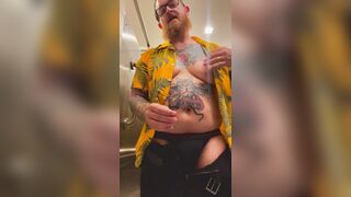 Bearded Tattooed Daddy jerks off in public restroom