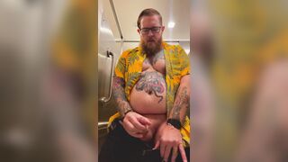 Bearded Tattooed Daddy jerks off in public restroom