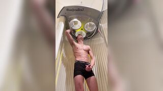 Fit guy enjoys a tense tanning session working out his ???? at the gym