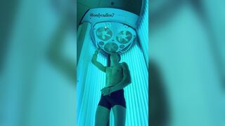 OF guy masturbates his cock while tanning????