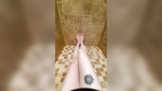 Freshly shaved legs and pussy glisten in the shower