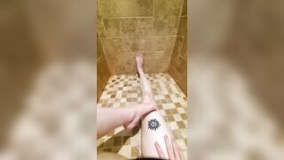 Freshly shaved legs and pussy glisten in the shower