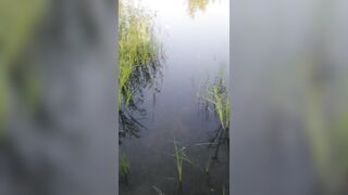 Transgirl swimming in clothes in lake wearing all black: pantyhose, skirt and top. Wetlook in lake.