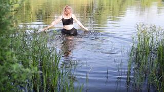 Swimming in lake in clothes. Black Wet skirt, wet stockings and tank top. Wetlook transgirl in lake.