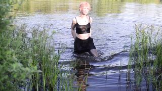 Swimming in lake in clothes. Black Wet skirt, wet stockings and tank top. Wetlook transgirl in lake.