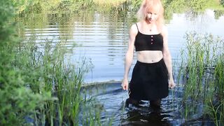 Swimming in lake in clothes. Black Wet skirt, wet stockings and tank top. Wetlook transgirl in lake.