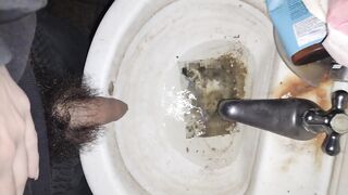 Hairy cock man pissing in old dirty sink