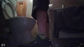 Sporty guy peeing at home