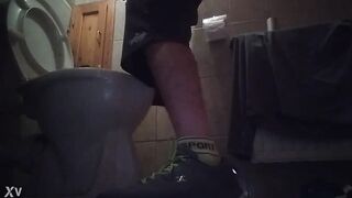 Sporty guy peeing at home