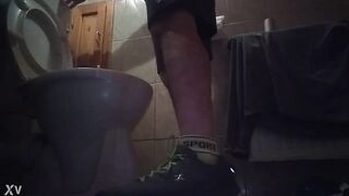 Sporty guy peeing at home